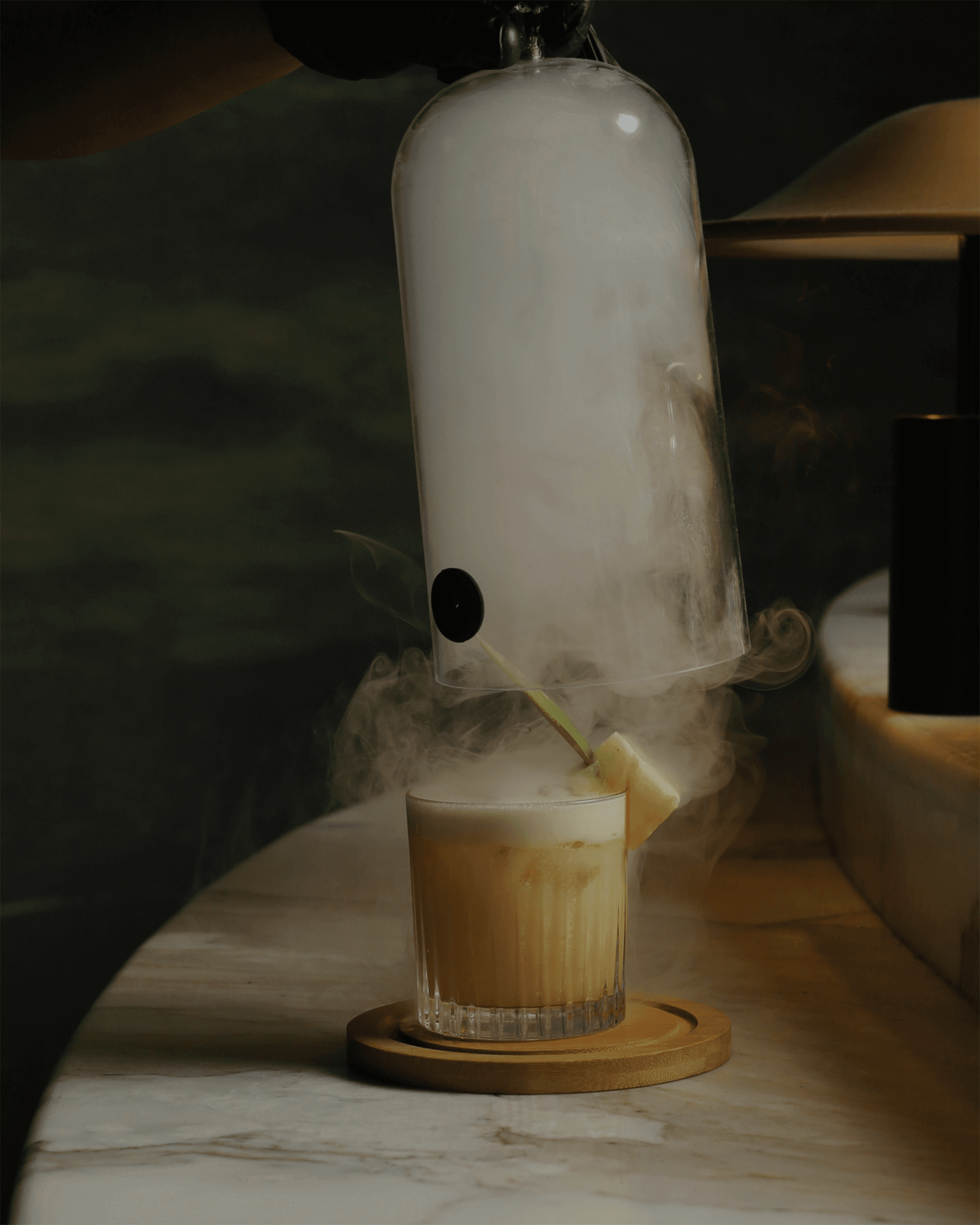A smoked signature cocktail served tableside